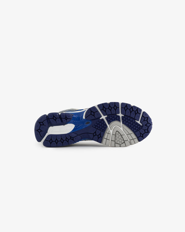 The image shows the outsole of a running shoe featuring a blue and gray design. The tread pattern is visible, indicating a focus on traction and stability for athletic performance.